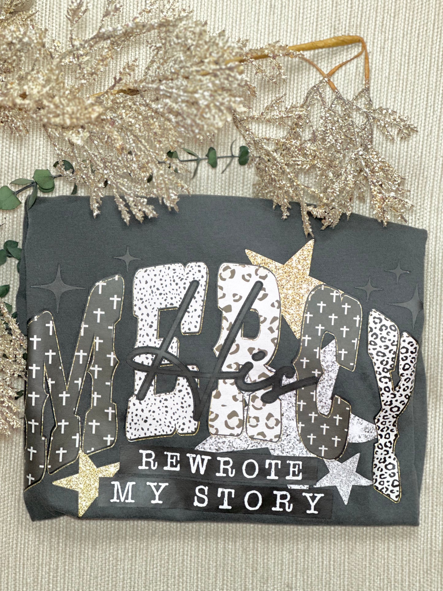 Decorative card with text 'ME rewrote MY STORY' on a textured surface with decorative elements.
