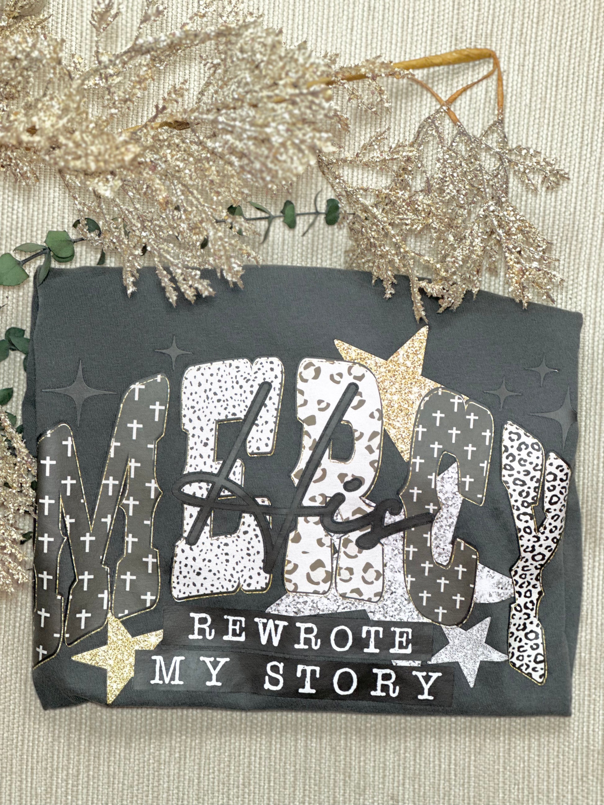 Decorative card with text 'ME rewrote MY STORY' on a textured surface with decorative elements.