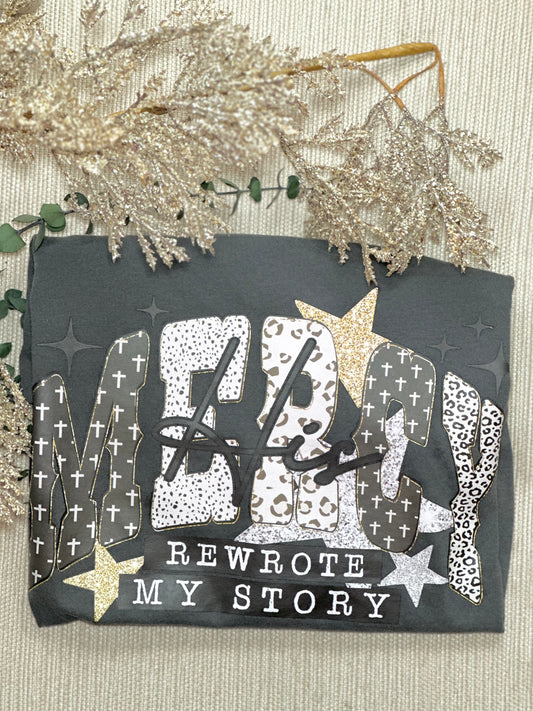 Decorative card with text 'ME rewrote MY STORY' on a textured surface with decorative elements.